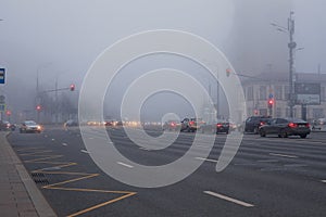 Thick white fog in Moscow. Cars on the Garden Ring. Russia. November 2021 Natural phenomenon. Smog.