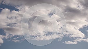Thickening white clouds in a blue sky timelapse.