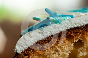 The thickness of the white confectionery glaze on Easter cake. A slice of homemade Easter baking closeup, macro shot