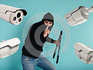 Thief with balaclava was spotted trying to steal in a apartment from the video surveillance system.