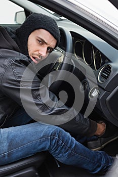 Thief breaking into a car