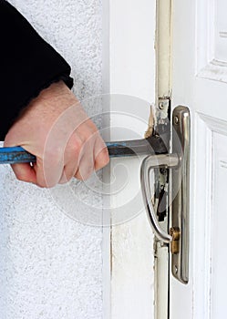 Thief breaking into a house