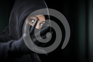 Thief broke into the apartment. House robbery by woman in a black jacket and black mask and crowbar. Burglar in a mask.