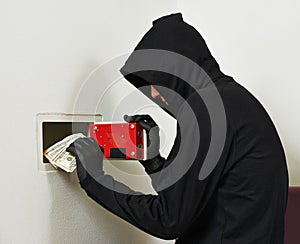 Thief burglar at house safe breaking