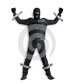 Thief or burglar masked with balaclava is caught and is taped to the wall with duct tape.