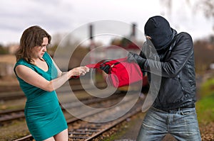 Thief is fighting with woman and stealing handbag