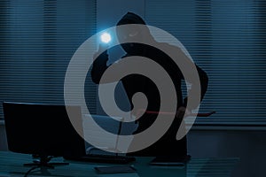 Thief With Flashlight In Office