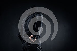 Thief hiding gun behind