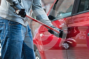 Thief Opening Car`s Door With Crowbar