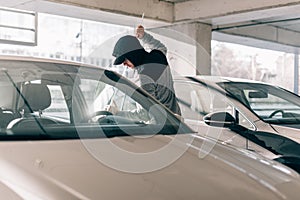 Thief robbing a car