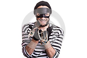 Thief showing stolen jewelry and smiling