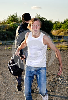 Thief stealing a backpack