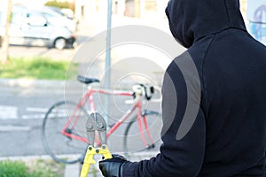 Thief stealing a bike in the city street