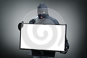 Thief stealing computer monitor