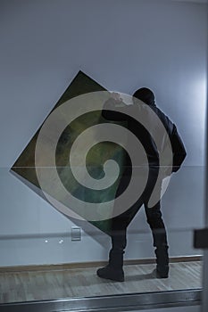 Thief stealing expensive painting