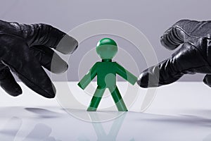 Thief Stealing Green Human Figure
