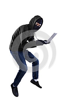 A thief is stealing a laptop computer