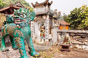 Statue of a chinese style lion in Thien Tru Pagoda photo