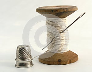 Thimble, needle and thread
