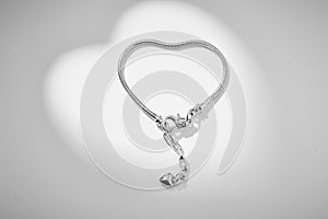 Thin chain of platinum on a  background. Jewelry chain made of white metal close-up.
