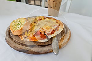 Thin crispy pizza cheese with salmon, ham, bacon on wood tray