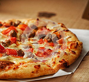 Thin crust Pizza, close up photo of a delicious pizza with mozzarella cheese, onions, meat, tomato