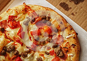 Thin crust Pizza, close up photo of a delicious pizza with mozzarella cheese, onions, meat, tomato