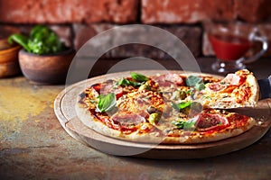 Thin crust pizza with ham, cheese and olive