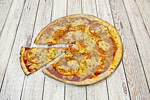 Thin crust pizza with thin tomato slices, melted mozzarella cheese, tomato sauce