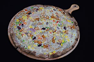 Thin crusted italian mix vegetables pizza in a wood board