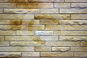 Embossed masonry brick in light brown with dark spots