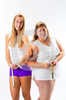 Thin and fat woman measuring waist with tape photo