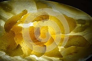Thin ginger slices in yellow light