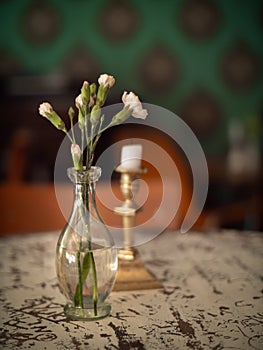 Thin Glass Vase with flowers and a candlestick