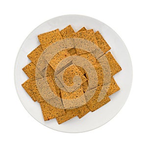 Thin gourmet snack crackers on a white plate