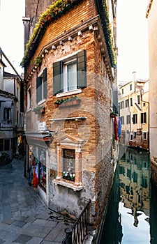 Thin house between canal and street in Venice, Italy