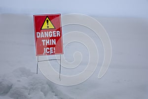 Thin ice warning near a frozen lake