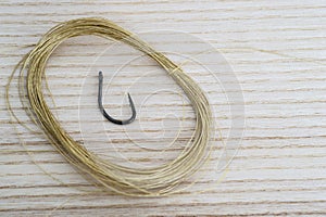 Thin Kevlar leash coiled rings and carp fishing hook.