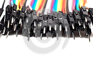 Thin multicolored wires with connectors, arduino wire on white background