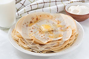 Thin pancakes with butter and honey