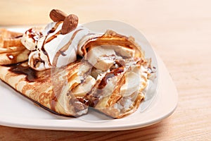 Thin pancakes served with chocolate syrup