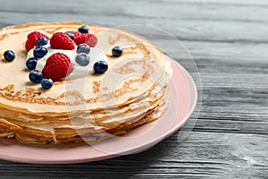 Thin pancakes served with cream and berries