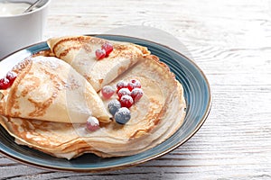 Thin pancakes served with sugar powder