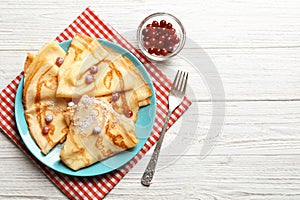 Thin pancakes served with sugar powder