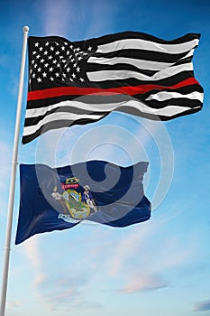 Thin Red Line Black Flag of US with smaller flag of Maine state, Usa at cloudy sky background. United states of America