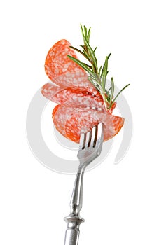 Thin salami slices and rosemary on fork