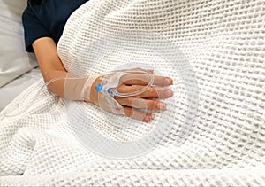 Drip tube inserted in right arm of patient in hospital