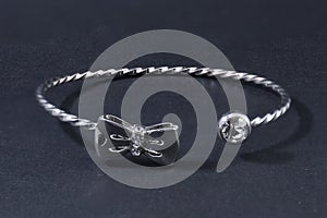 Thin silver bracelet isolated on black