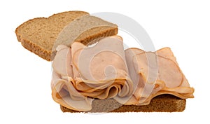 Thin sliced smoked turkey sandwich on a white background