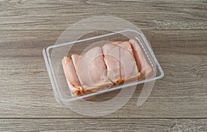 Thin sliced smoked turkey slices in a plastic tray on a table